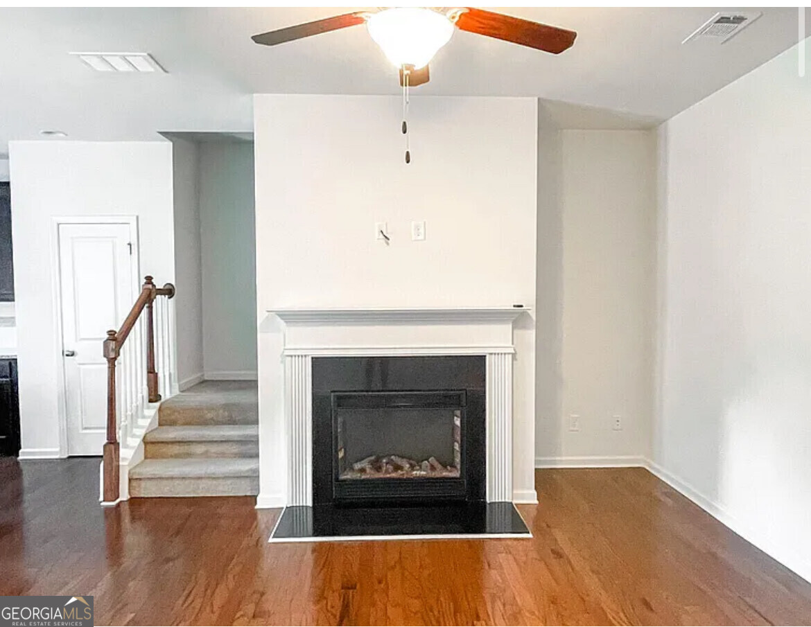 2686 Avanti Way Decatur, GA 30035 - Photo 2 of 6 a living room with wooden floor and a fireplace
