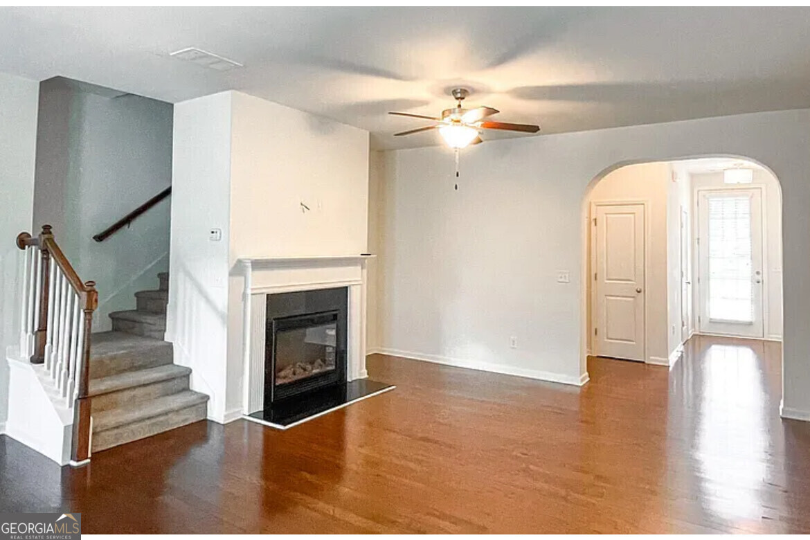 2686 Avanti Way Decatur, GA 30035 - Photo 5 of 6 a view of an empty room with wooden floor fireplace and a window