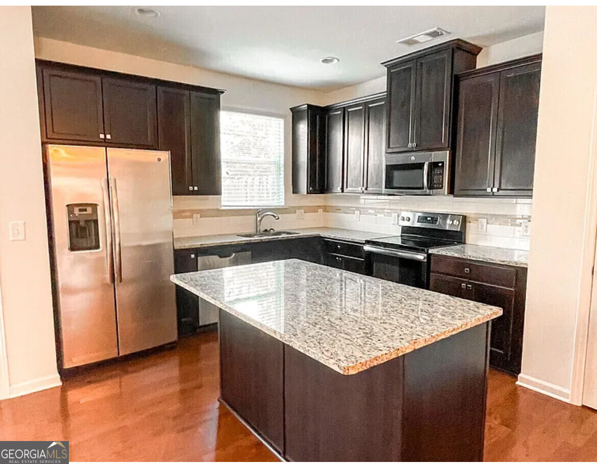 2686 Avanti Way Decatur, GA 30035 - Photo 6 of 6 a kitchen with stainless steel appliances granite countertop a sink stove and refrigerator
