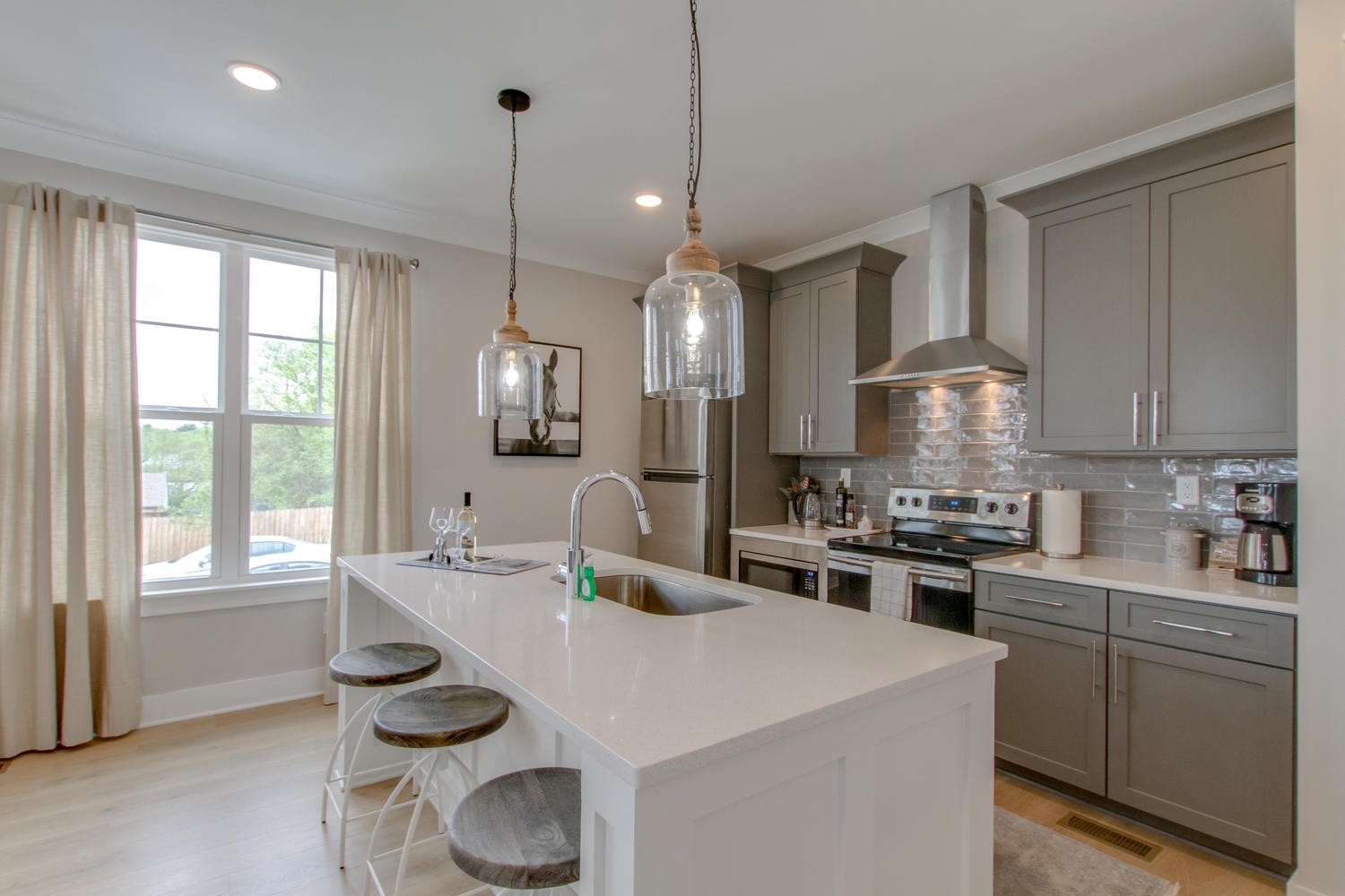 105 Duke Street, Unit 7 Nashville, TN 37207 - Photo 7 of 26 a kitchen with sink stove and white cabinets