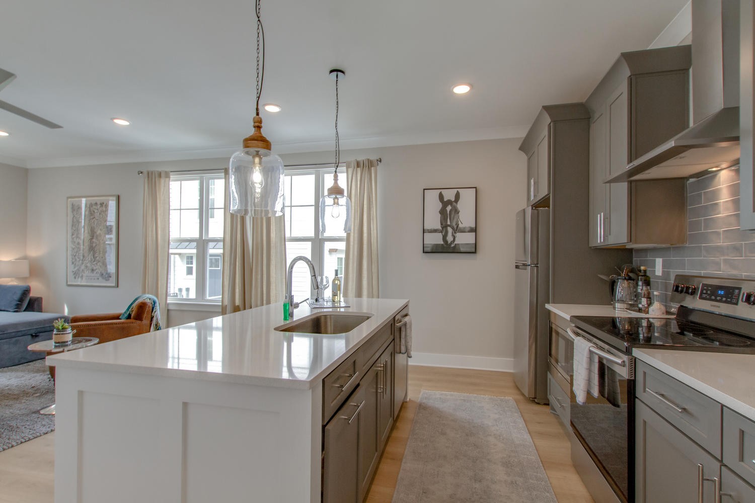 105 Duke Street, Unit 7 Nashville, TN 37207 - Photo 8 of 26 a kitchen with stainless steel appliances granite countertop a sink a stove and a wooden floors