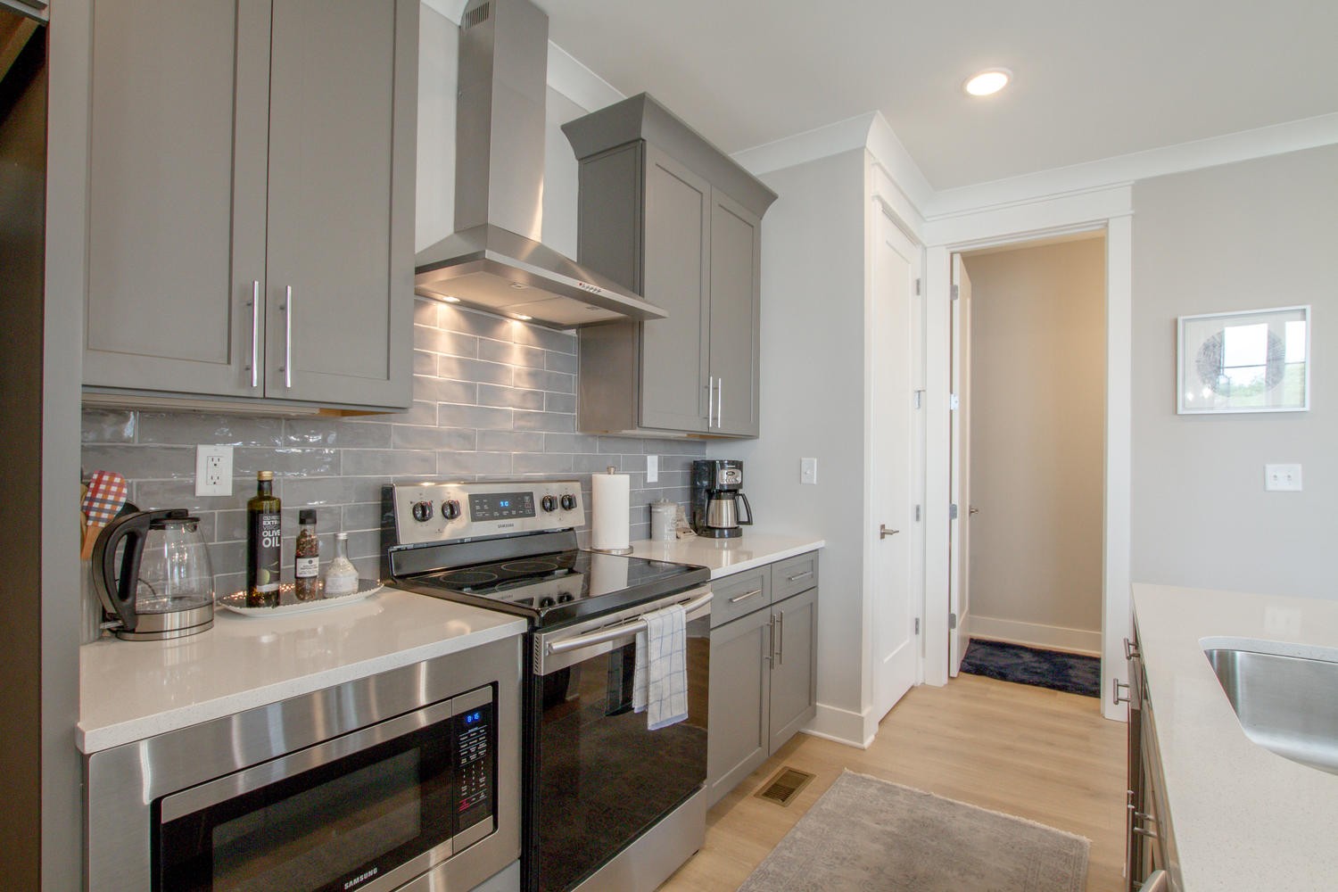 105 Duke Street, Unit 7 Nashville, TN 37207 - Photo 9 of 26 a kitchen with stainless steel appliances a stove a sink and cabinets
