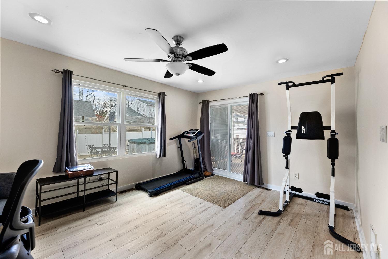 27 George Street Avenel, NJ 07001 - Photo 17 of 36 a living room with furniture window and gym equipment