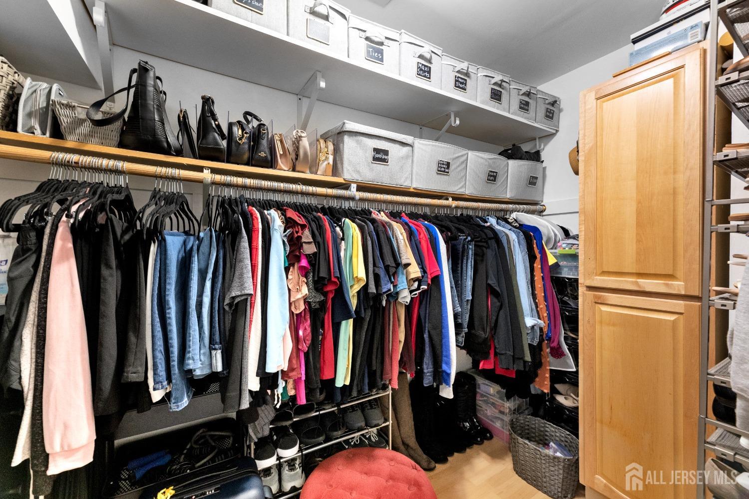 27 George Street Avenel, NJ 07001 - Photo 25 of 36 a view of walk in closet with clothes and shoes