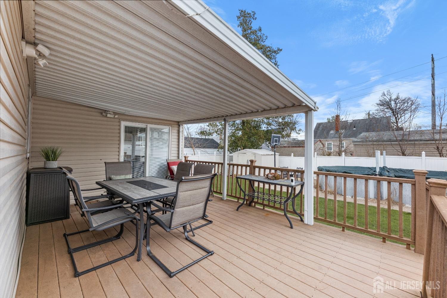 27 George Street Avenel, NJ 07001 - Photo 30 of 36 a roof deck with table and chairs and wooden floor