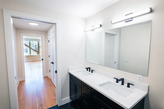 a bathroom with a sink a mirror and a shower