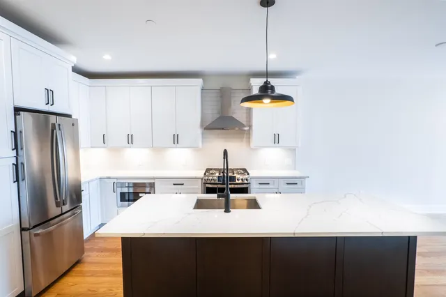 a kitchen with a sink a refrigerator and window