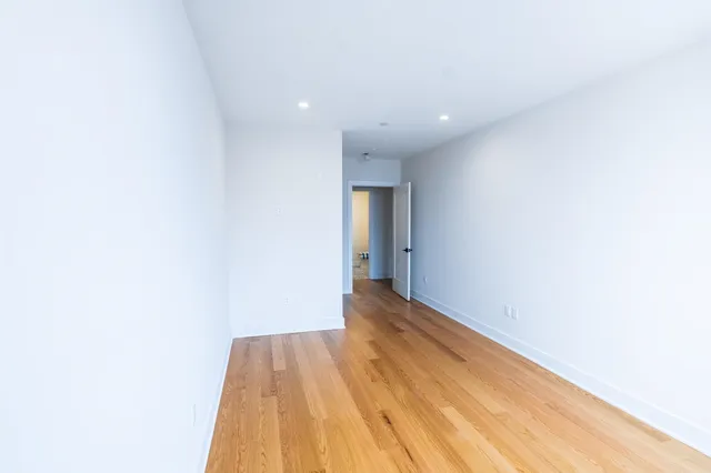 a view of an empty room and wooden floor