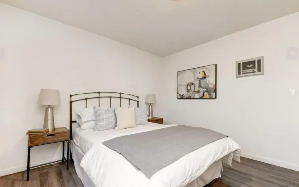 a bedroom with a bed and a table