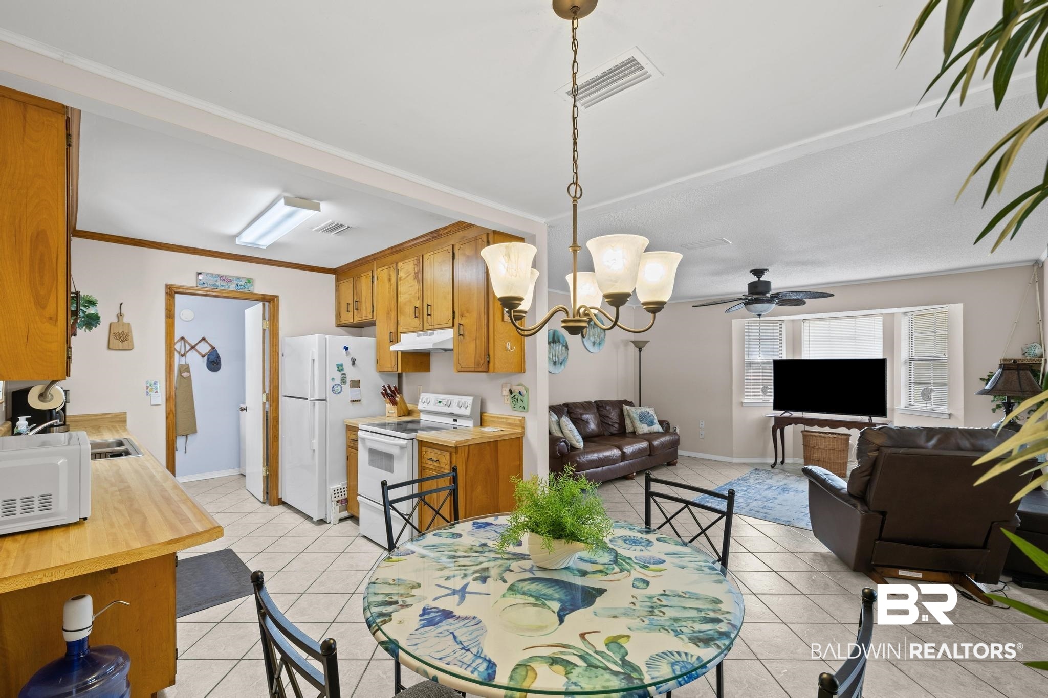 1437 Rio Circle Lillian, AL 36549 - Photo 6 of 46 Dining space featuring suspended lighting, ornamental molding, and light tile patterned floors