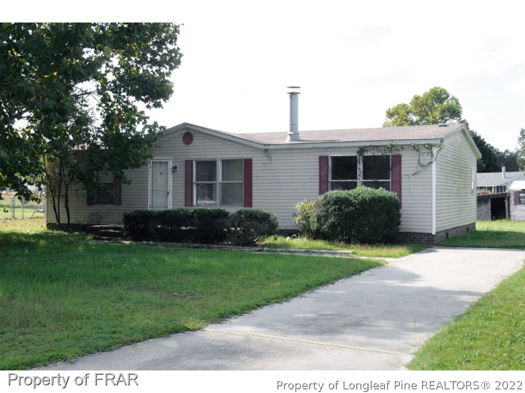 4832 Backbay Road Fayetteville, NC 28306 - Photo 1 of 18 a front view of a house with a yard