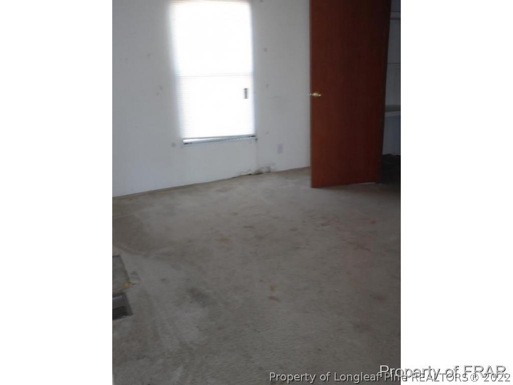 4832 Backbay Road Fayetteville, NC 28306 - Photo 14 of 18 a view of an empty room with a window