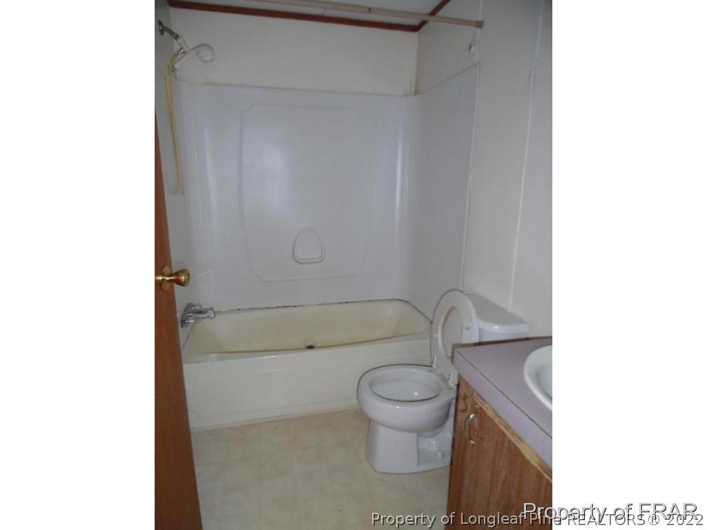 4832 Backbay Road Fayetteville, NC 28306 - Photo 16 of 18 a bathroom with a toilet and a shower