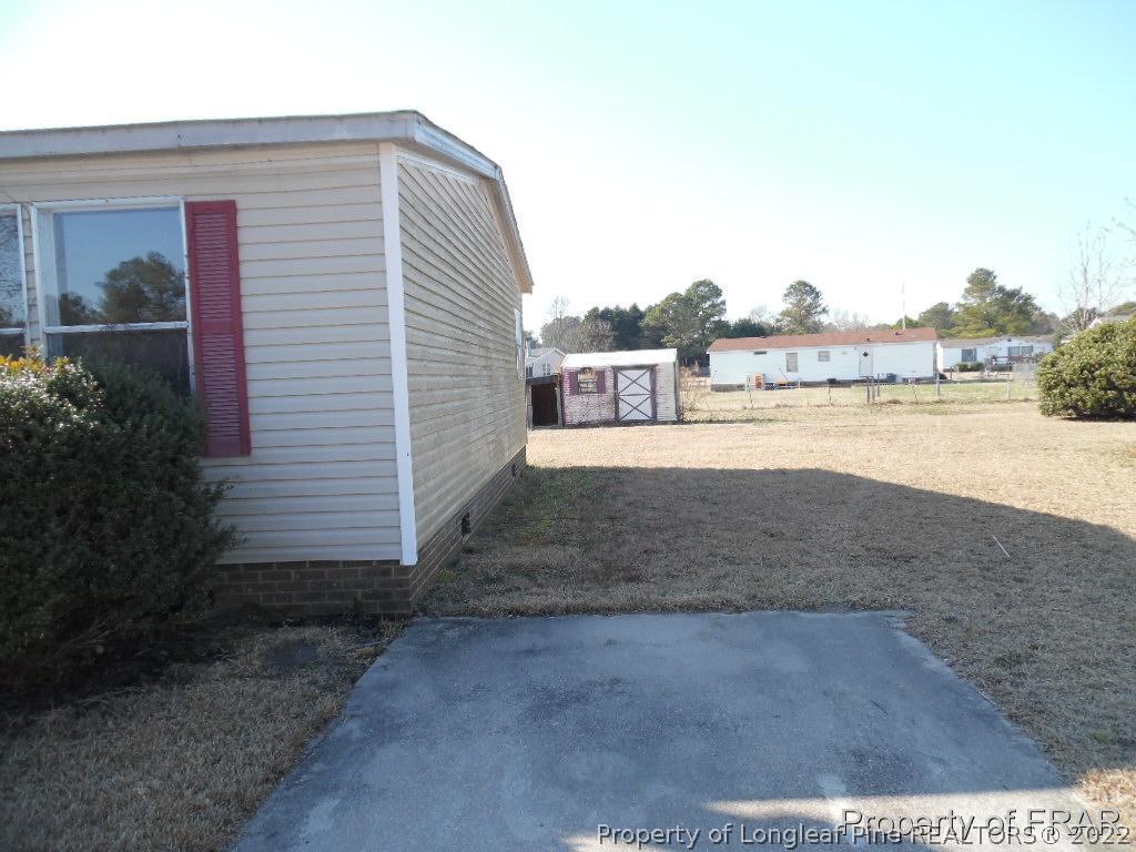 4832 Backbay Road Fayetteville, NC 28306 - Photo 2 of 18 a view of a dry yard with a house
