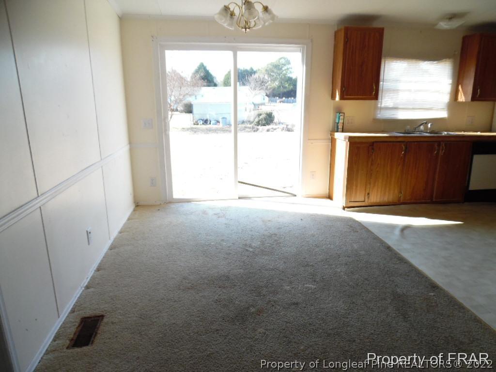 4832 Backbay Road Fayetteville, NC 28306 - Photo 7 of 18 a view of an empty room with a window