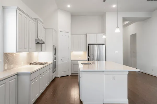 a kitchen with stainless steel appliances and white cabinets