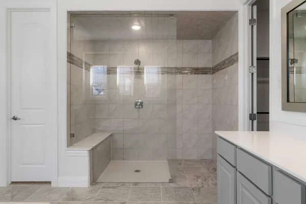 a bathroom with a tub sink and mirror