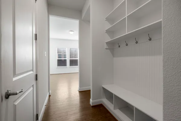 a view of walk in closet with empty racks