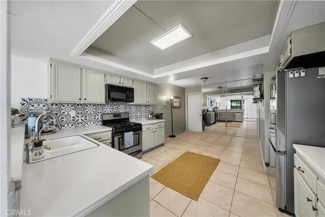 a kitchen with stainless steel appliances a stove sink and cabinets