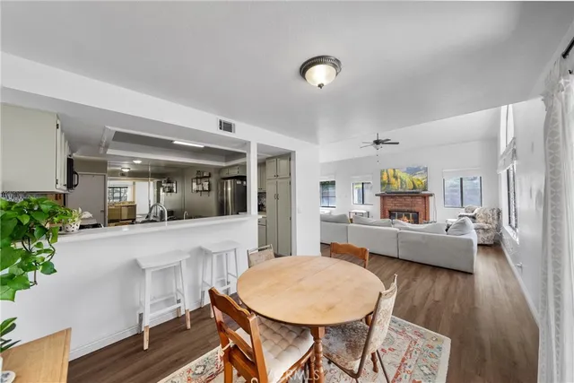 a dining room with furniture and wooden floor