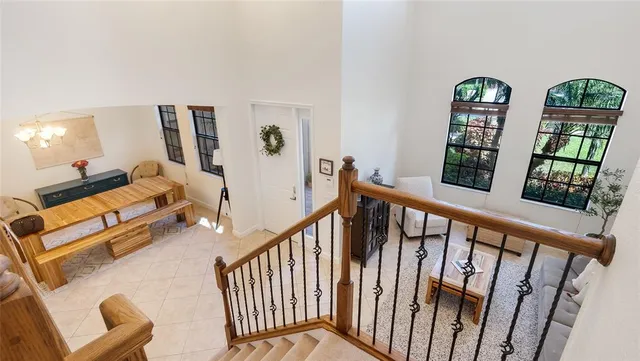 a living room with furniture and floor to ceiling window