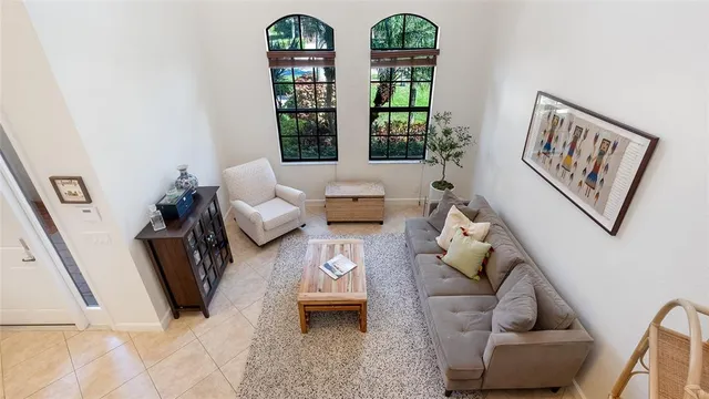 a kitchen with stainless steel appliances granite countertop a refrigerator a stove a kitchen island and chairs with wooden floor