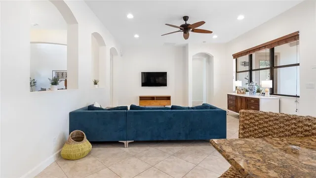 a living room with furniture and kitchen view