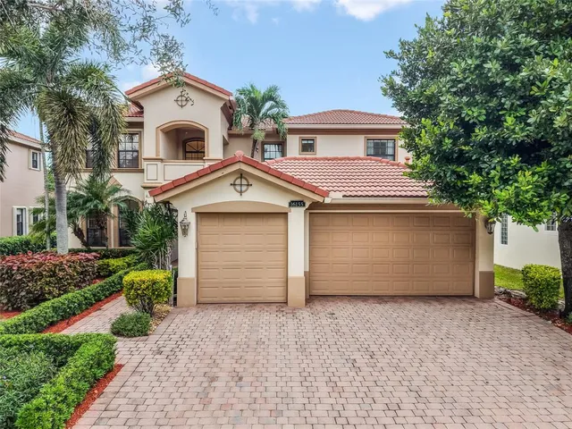 a view of a white house with a yard and garage