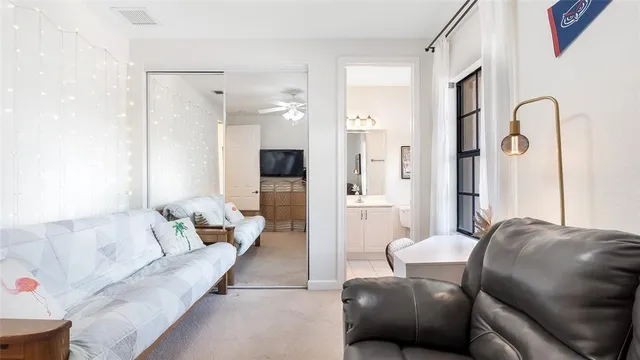 a living room with furniture a couch and a flat screen tv