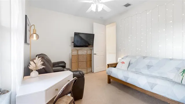 a bedroom with a bed and a chandelier