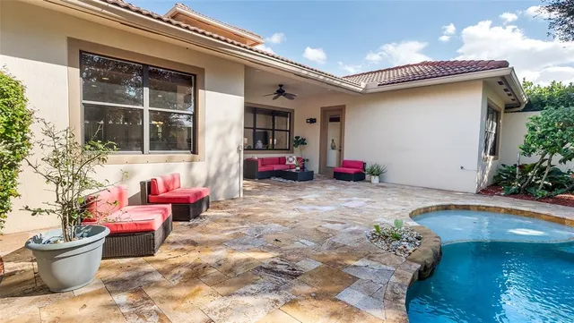 a view of house with swimming pool and porch