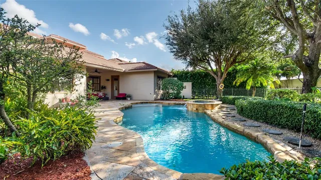 a view of a swimming pool with outdoor seating
