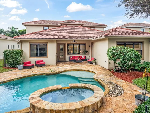 an aerial view of a house with a yard and large trees