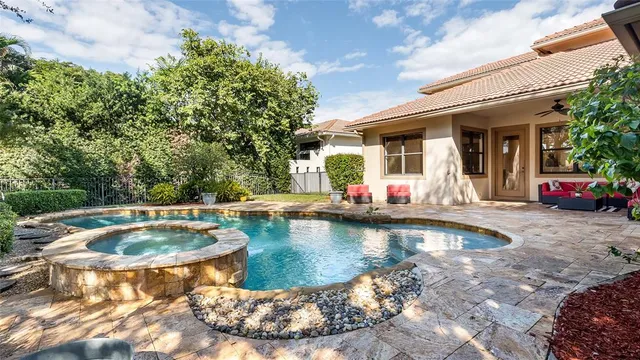 an aerial view of a house with a garden and swimming pool
