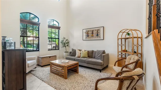 a living room with furniture a window and a dining table with garden view