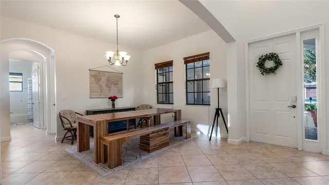 a view of kitchen with kitchen island stainless steel appliances a stove and a chandelier
