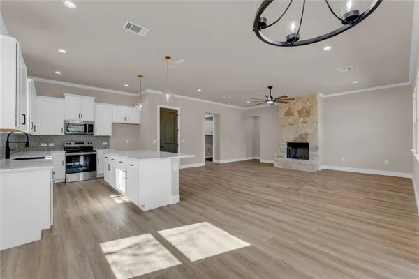 a large kitchen with cabinets and stainless steel appliances