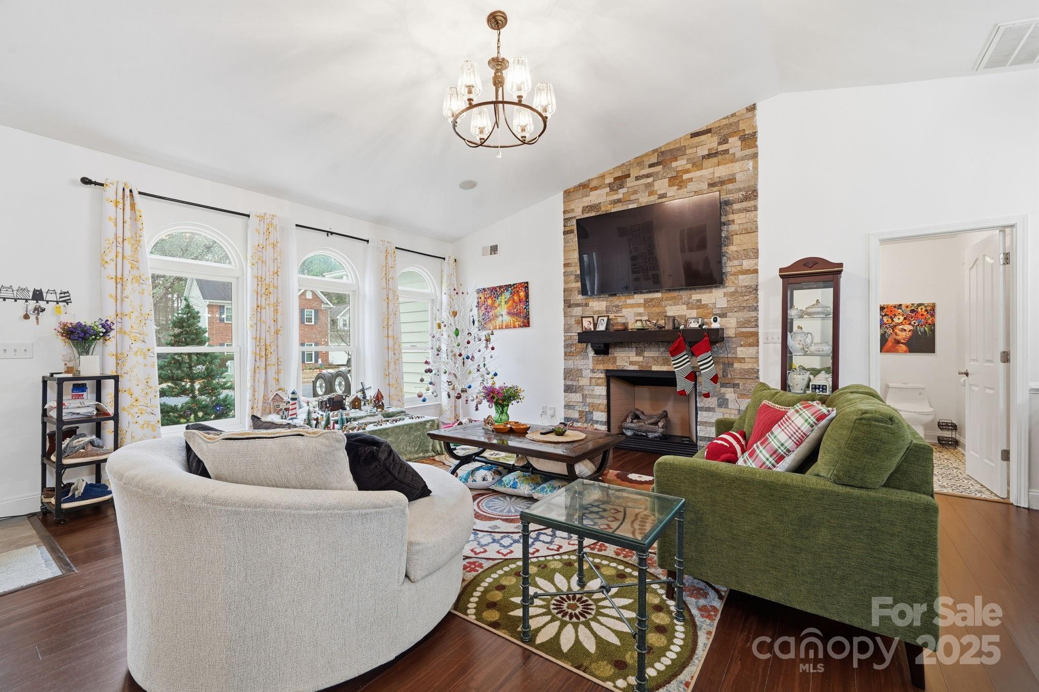 13512 Michael Lynn Road Charlotte, NC 28278 - Photo 13 of 36 a living room with furniture a flat screen tv and a fireplace