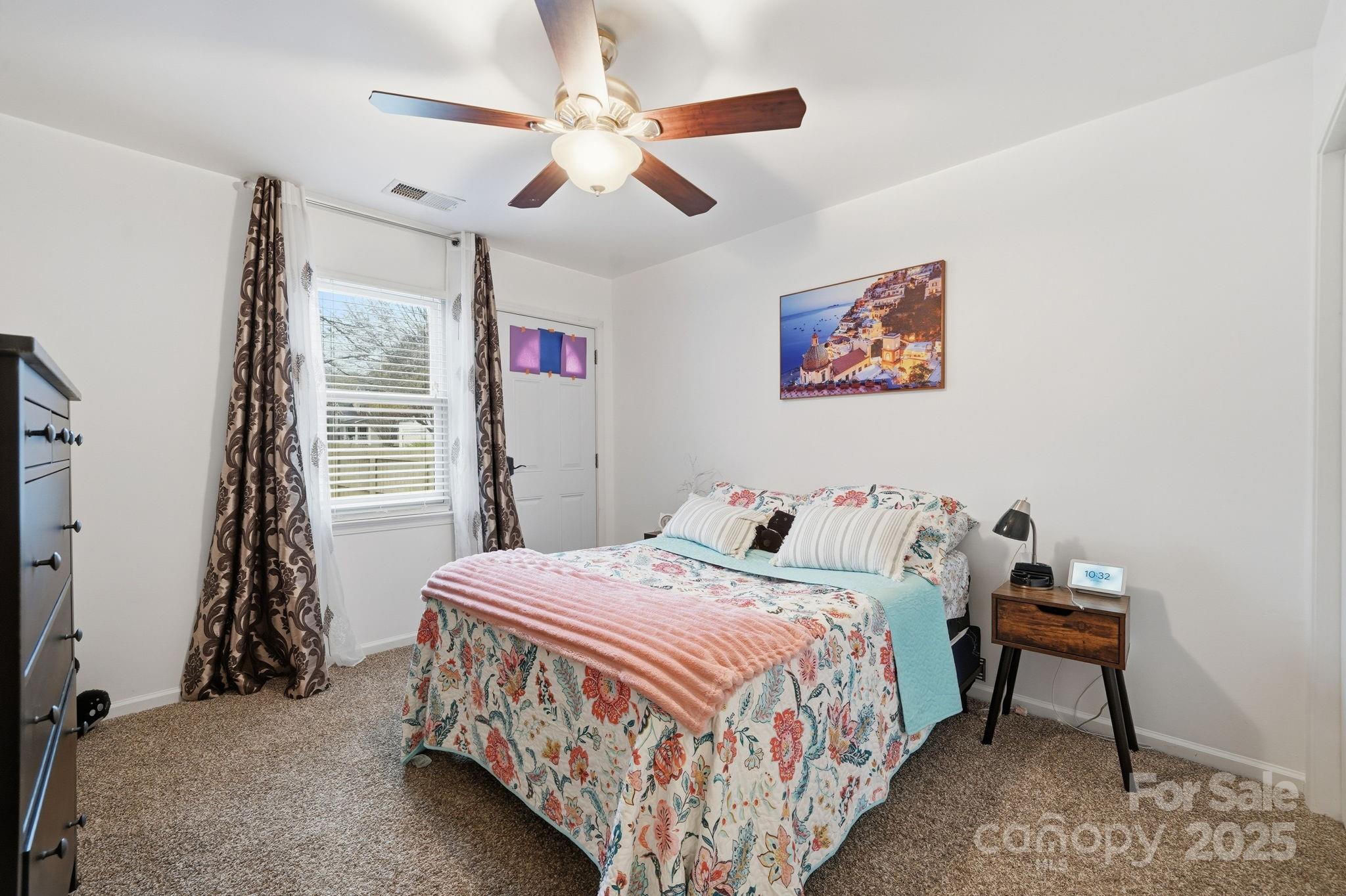 13512 Michael Lynn Road Charlotte, NC 28278 - Photo 19 of 36 a bedroom with a bed and a chandelier