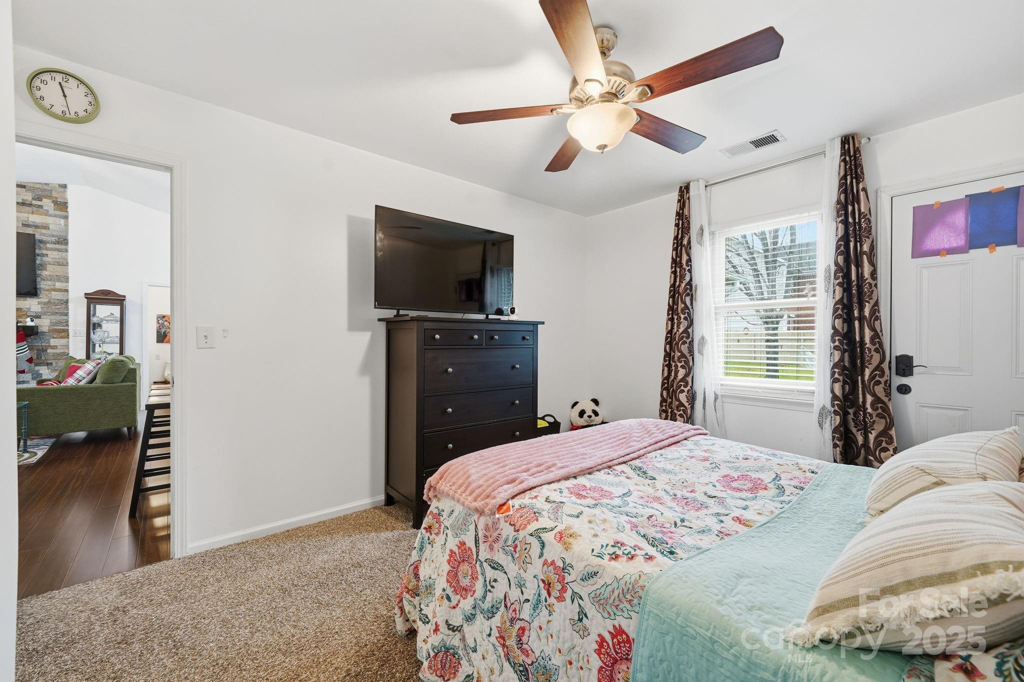 13512 Michael Lynn Road Charlotte, NC 28278 - Photo 20 of 36 a bedroom with a bed and a flat screen tv