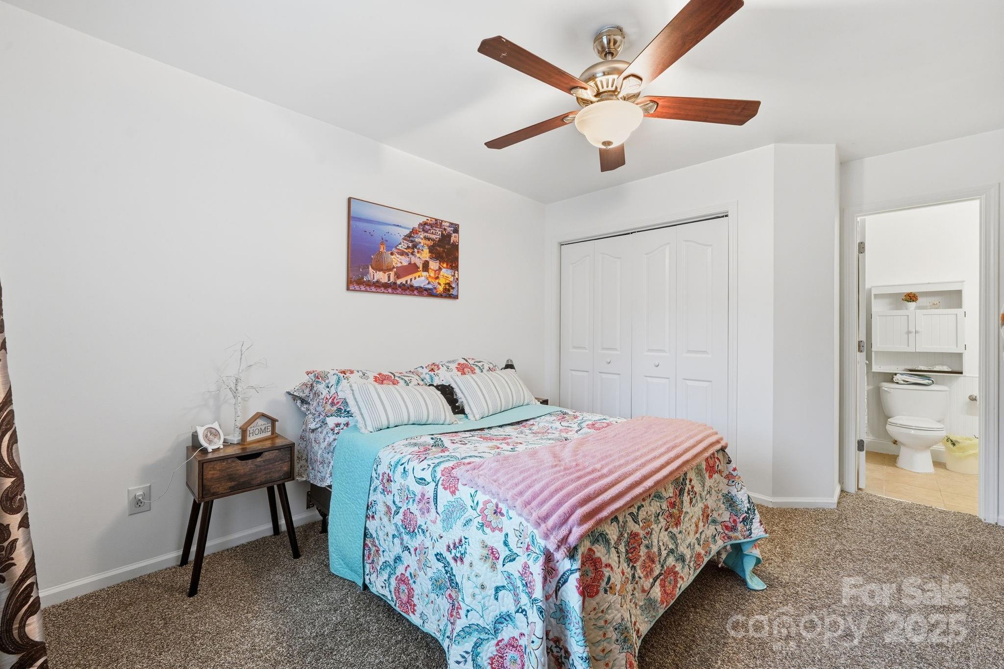 13512 Michael Lynn Road Charlotte, NC 28278 - Photo 21 of 36 a bedroom that has a bed and a table in it