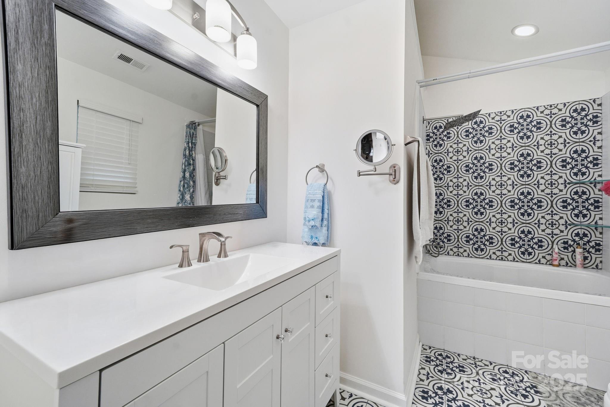 13512 Michael Lynn Road Charlotte, NC 28278 - Photo 22 of 36 a bathroom with a sink a toilet a shower and a mirror