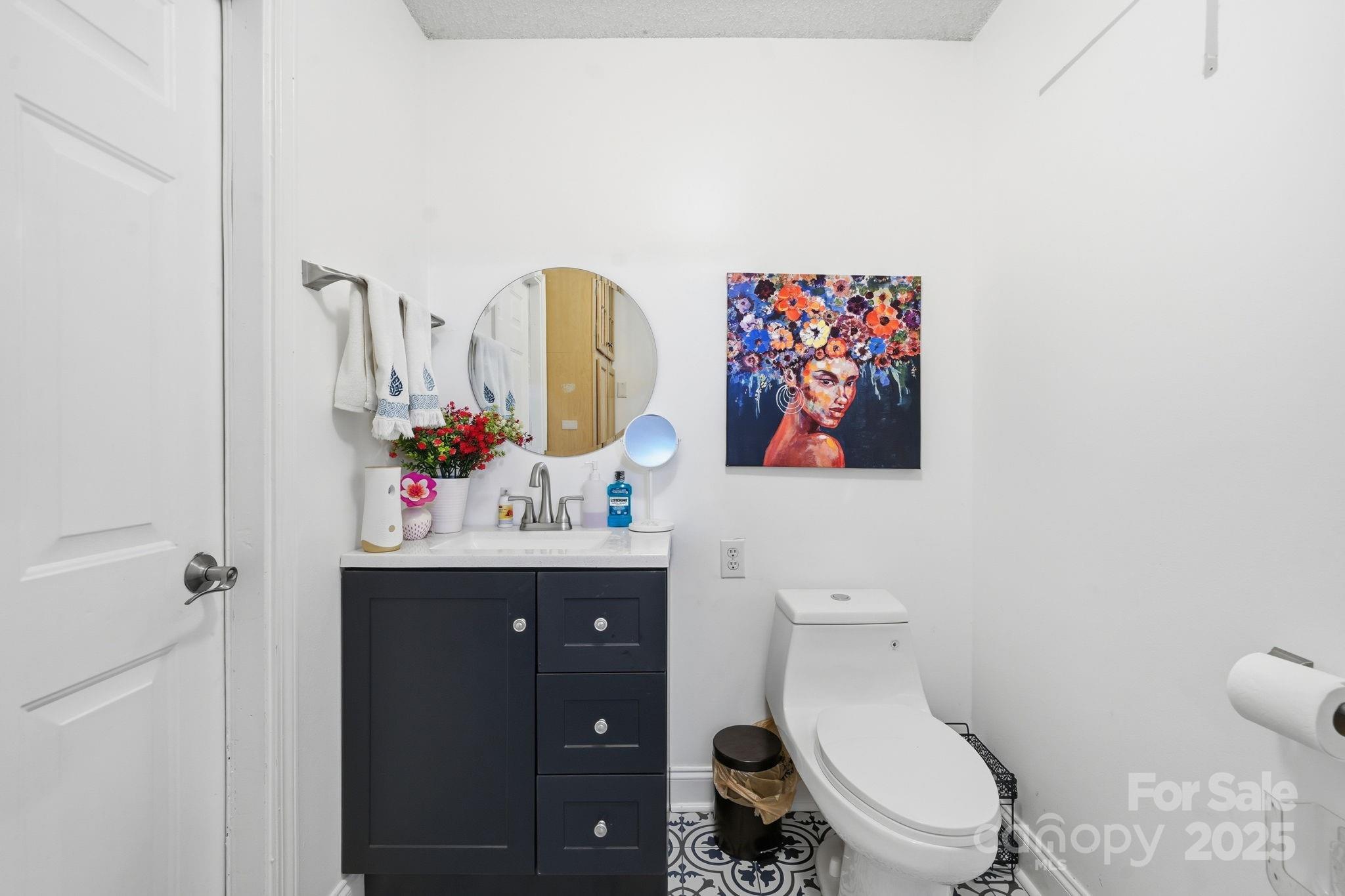 13512 Michael Lynn Road Charlotte, NC 28278 - Photo 24 of 36 a bathroom with a toilet sink and mirror