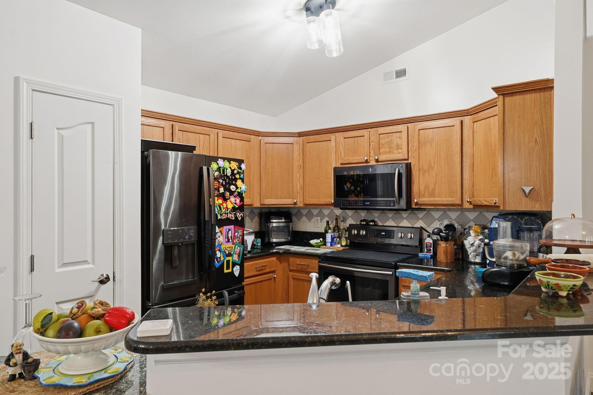 13512 Michael Lynn Road Charlotte, NC 28278 - Photo 5 of 36 a kitchen with a stove a sink and a refrigerator