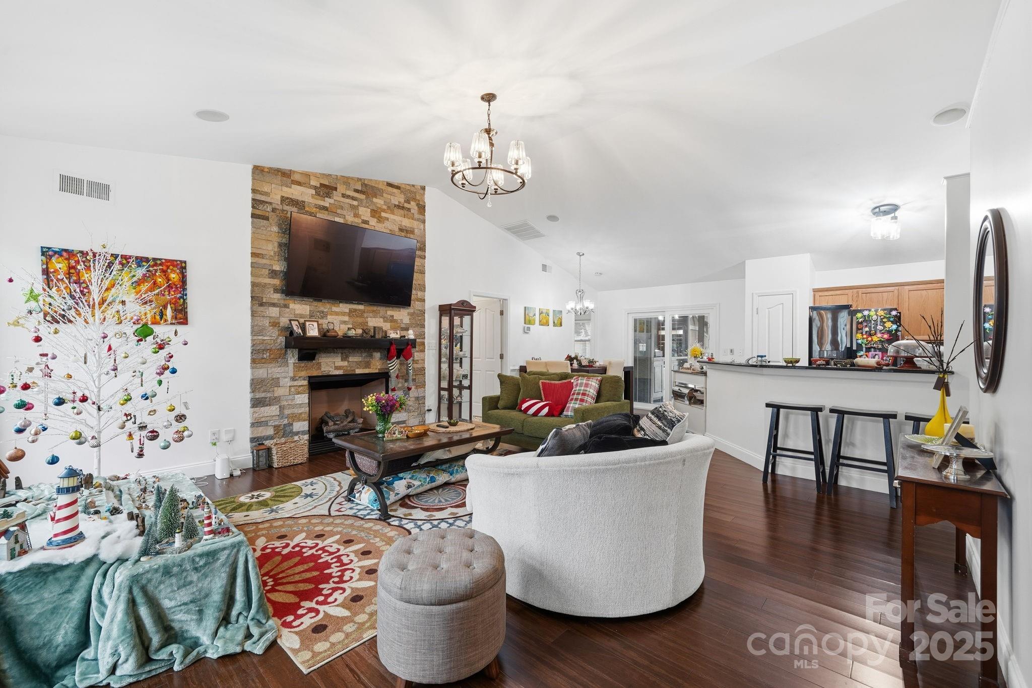 13512 Michael Lynn Road Charlotte, NC 28278 - Photo 8 of 36 a living room with furniture a flat screen tv and kitchen view