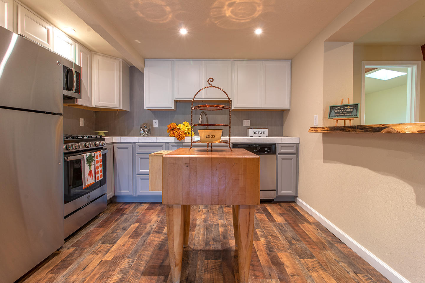 53475 Tollgate Road Idyllwild, CA 92549 - Photo 5 of 46 a kitchen with stainless steel appliances granite countertop a stove a sink dishwasher and a refrigerator