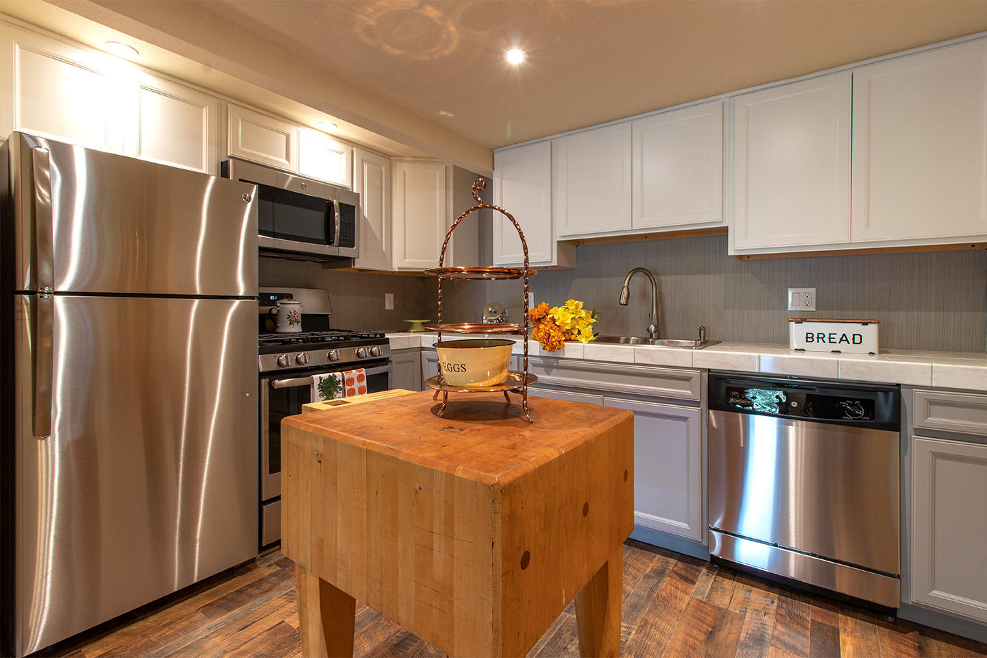 53475 Tollgate Road Idyllwild, CA 92549 - Photo 6 of 46 a kitchen with stainless steel appliances a refrigerator a sink a stove a microwave and wooden cabinets
