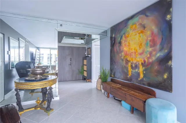 a living room with furniture and a painting on the wall