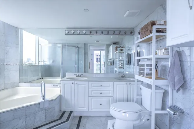 a bathroom with a granite countertop sink toilet and bathtub