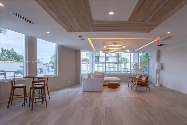 a living room with furniture and large windows
